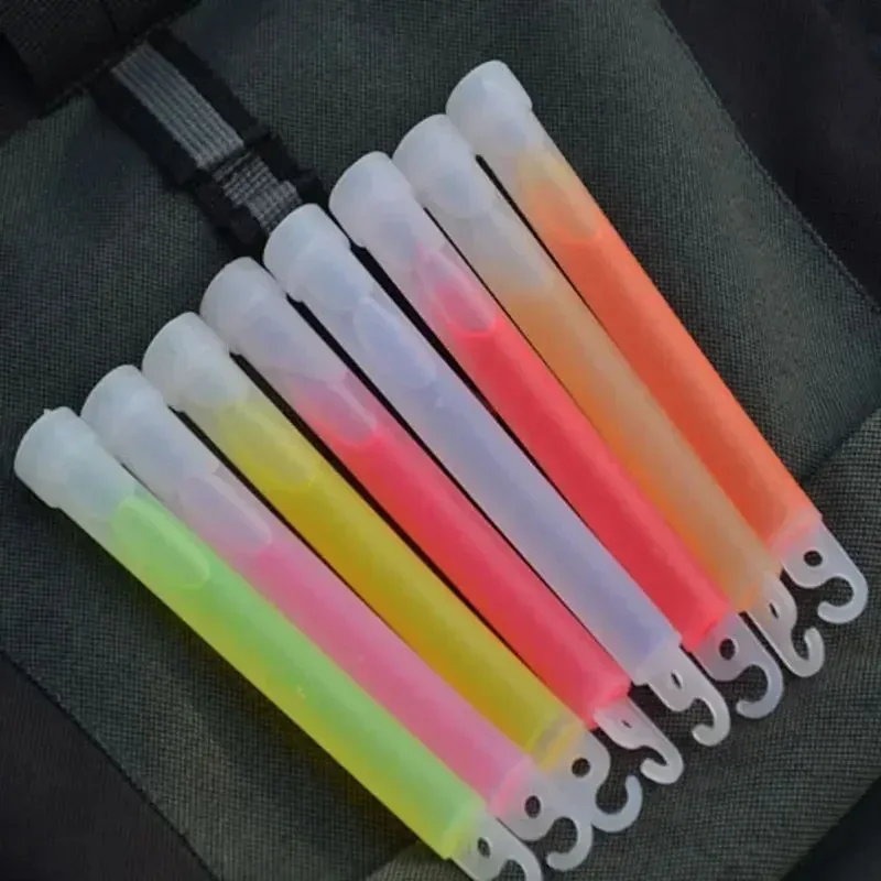 Multi-colored glow sticks with hooks laid across a backpack strap